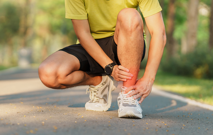 Runner holding a painful injured ankle showing outer instability.