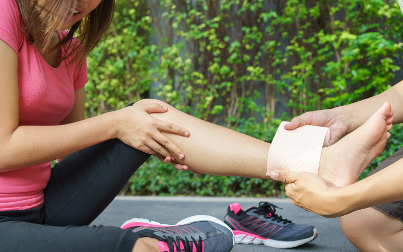 First aid bandage applied to a runner's high ankle sprain.