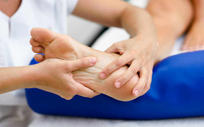 Orthopedic specialist examining patient foot pain.